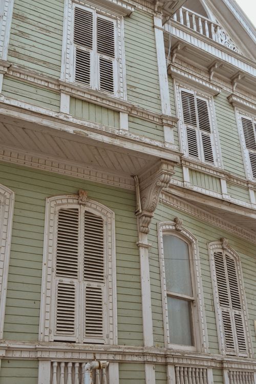 Free Charming old wooden house with classic shutters captured from a low angle. Stock Photo