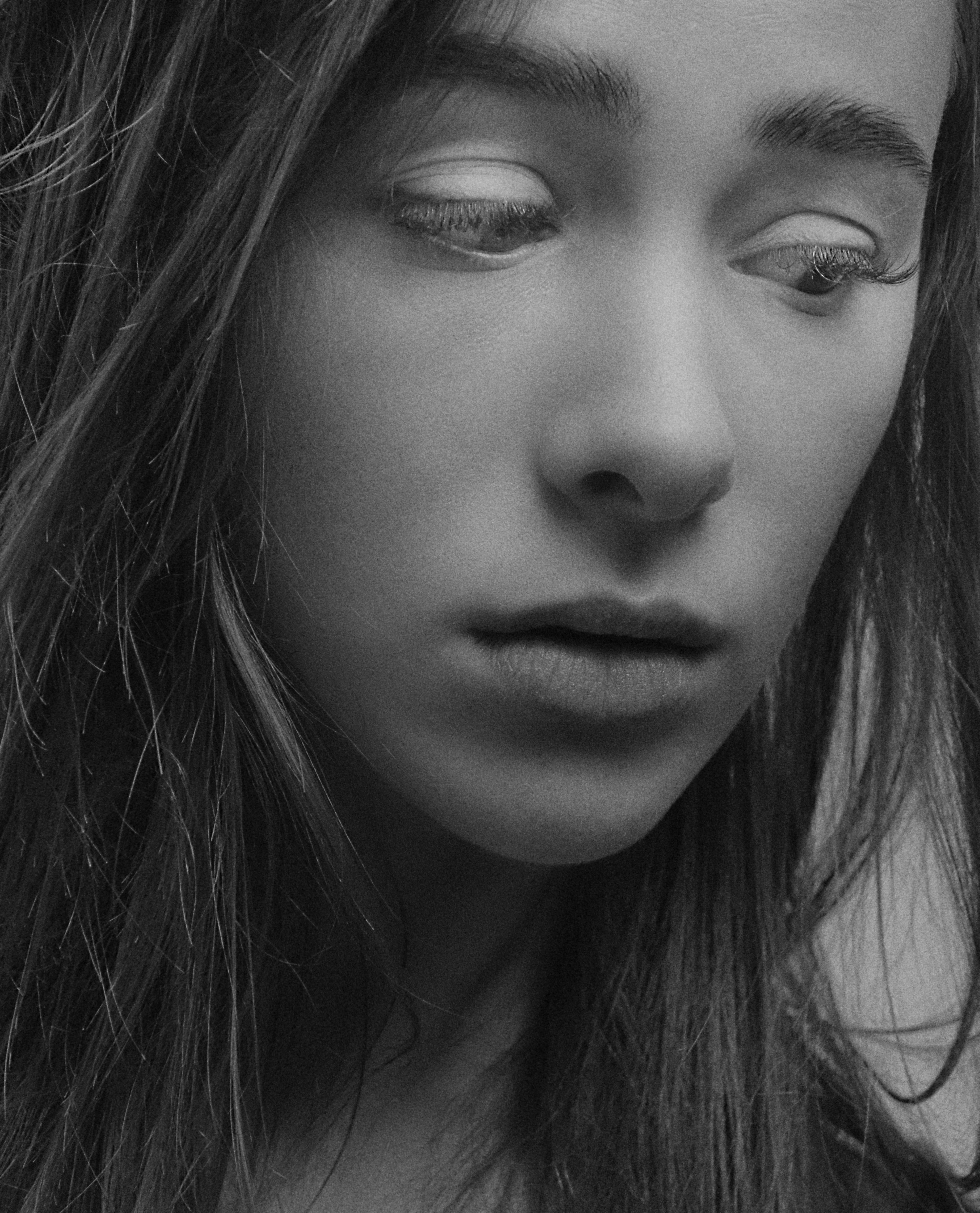 grayscale photo of a girl looking down