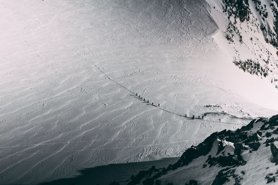 Climbers traversing snowy slopes of Mont Blanc, France, during wintertime.