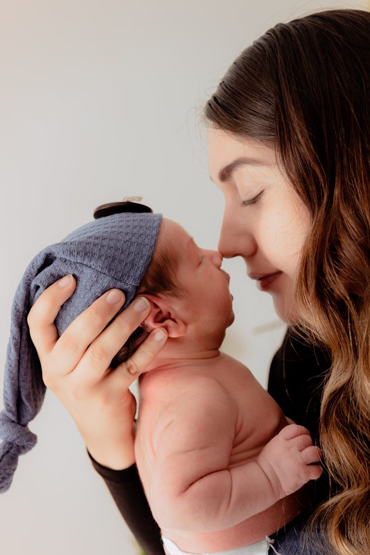 A Woman Holding A Newborn Baby 