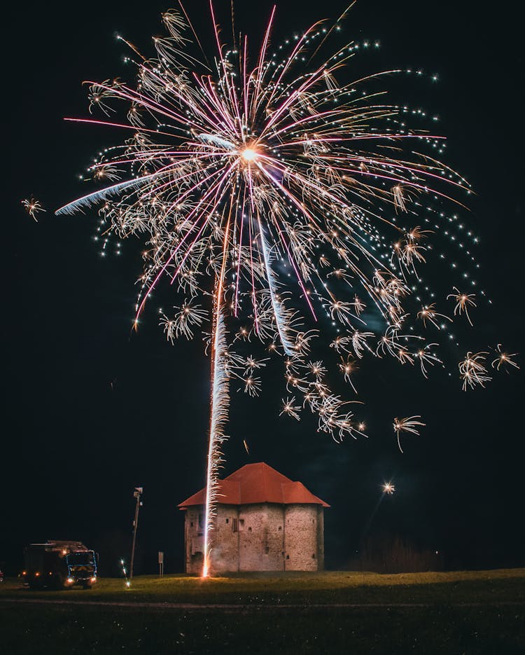 Fireworks Over Building And Truck At Night