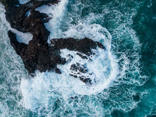 Top View of Waves Crashing on the Rocky Shore