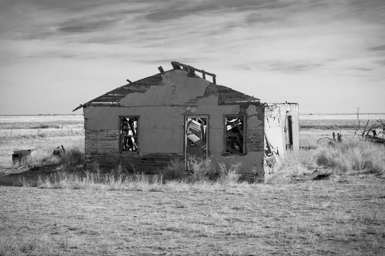 A Grayscale Of An Abandoned House