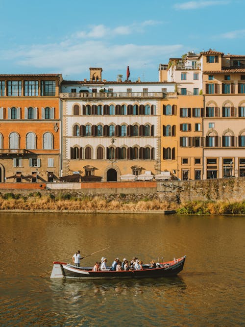 People in a Gondola on a Canal in Florence, Italy 