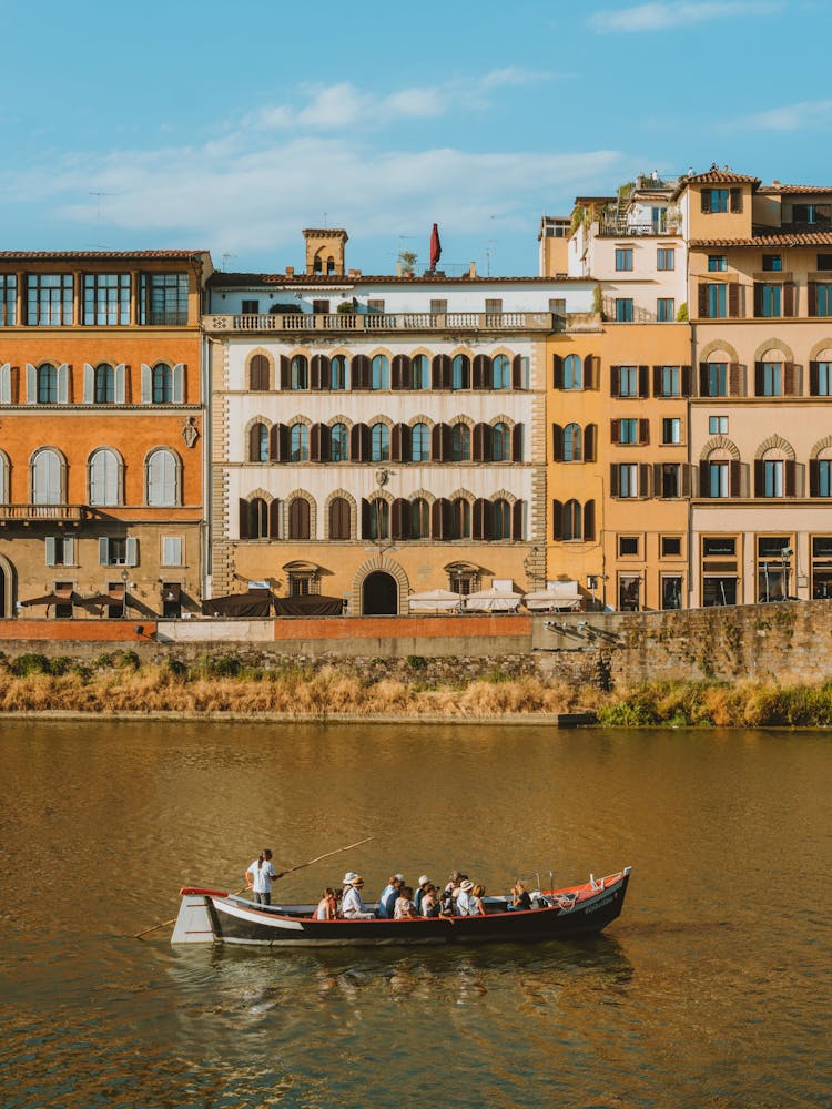 People In A Gondola On A Canal In Florence, Italy 