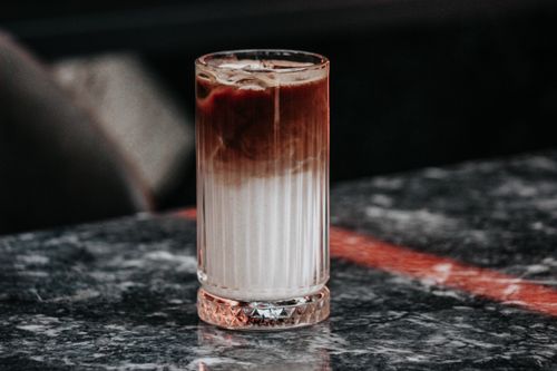 Free Chilled iced coffee in a clear glass on a marble surface, perfect for a refreshing break. Stock Photo