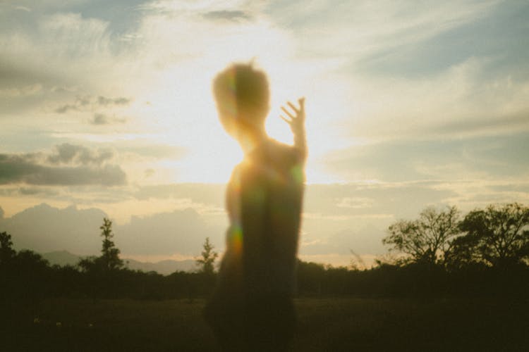 Blurred Silhouette Of A Man With An Arm Raised