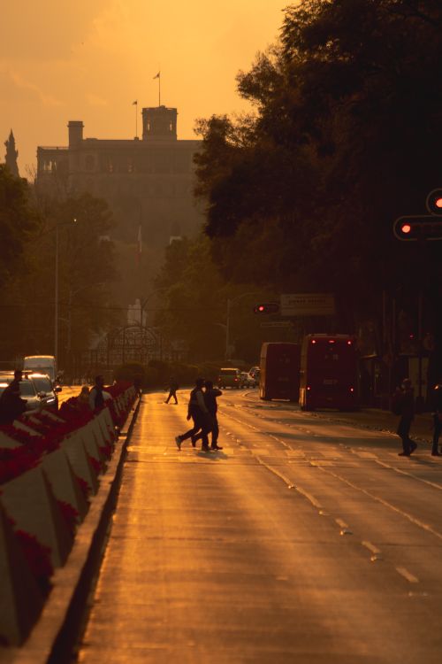 Free Urban sunset in Mexico City with people crossing, vibrant skyline, and warm glow. Stock Photo