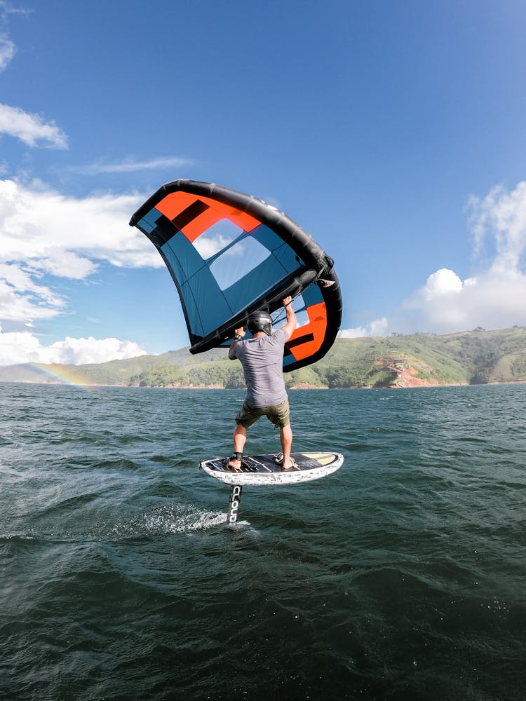 Man On Paddle With Sail