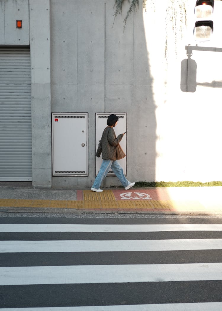 Woman Walking On Sidewalk