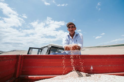 A Man Holding Grain