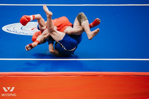 Two Men Wrestling on a Mat