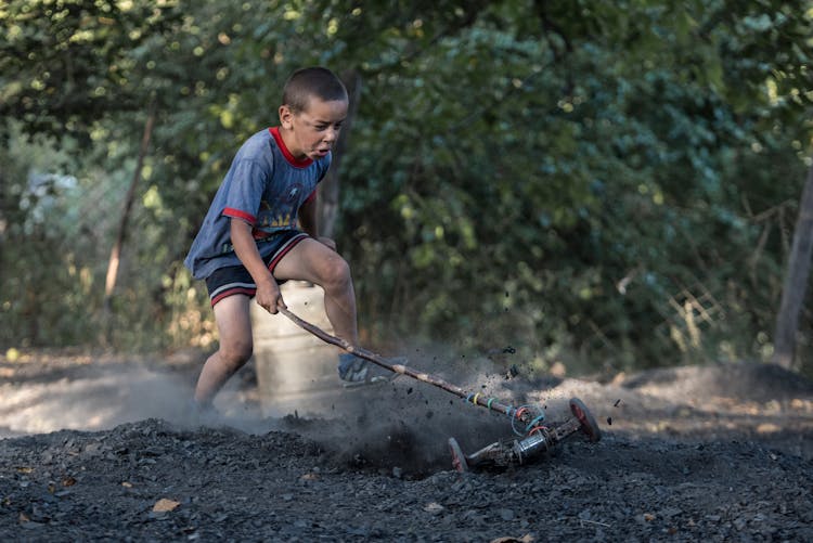 A Boy Playing In A Yard