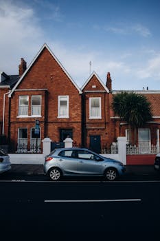 Scenic view of red brick houses with a car parked on a street.