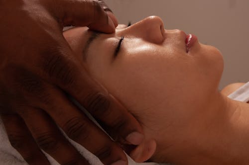 Photo of a Woman Getting a Face Massage