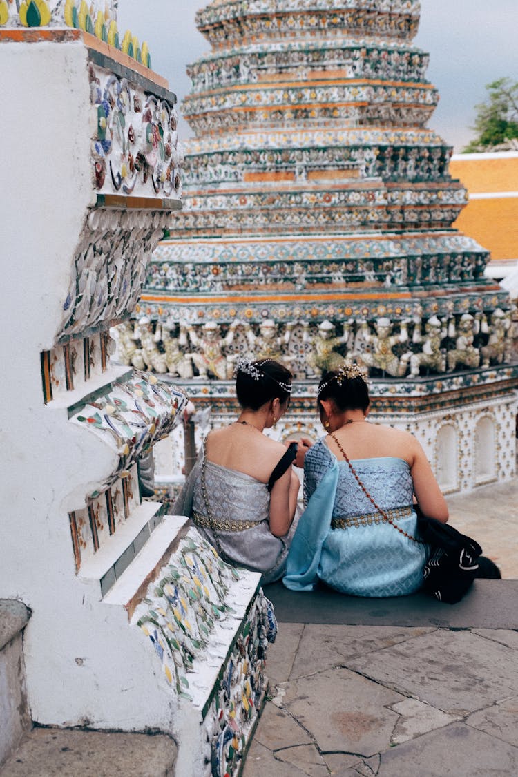 Women Sitting On Temple Steps