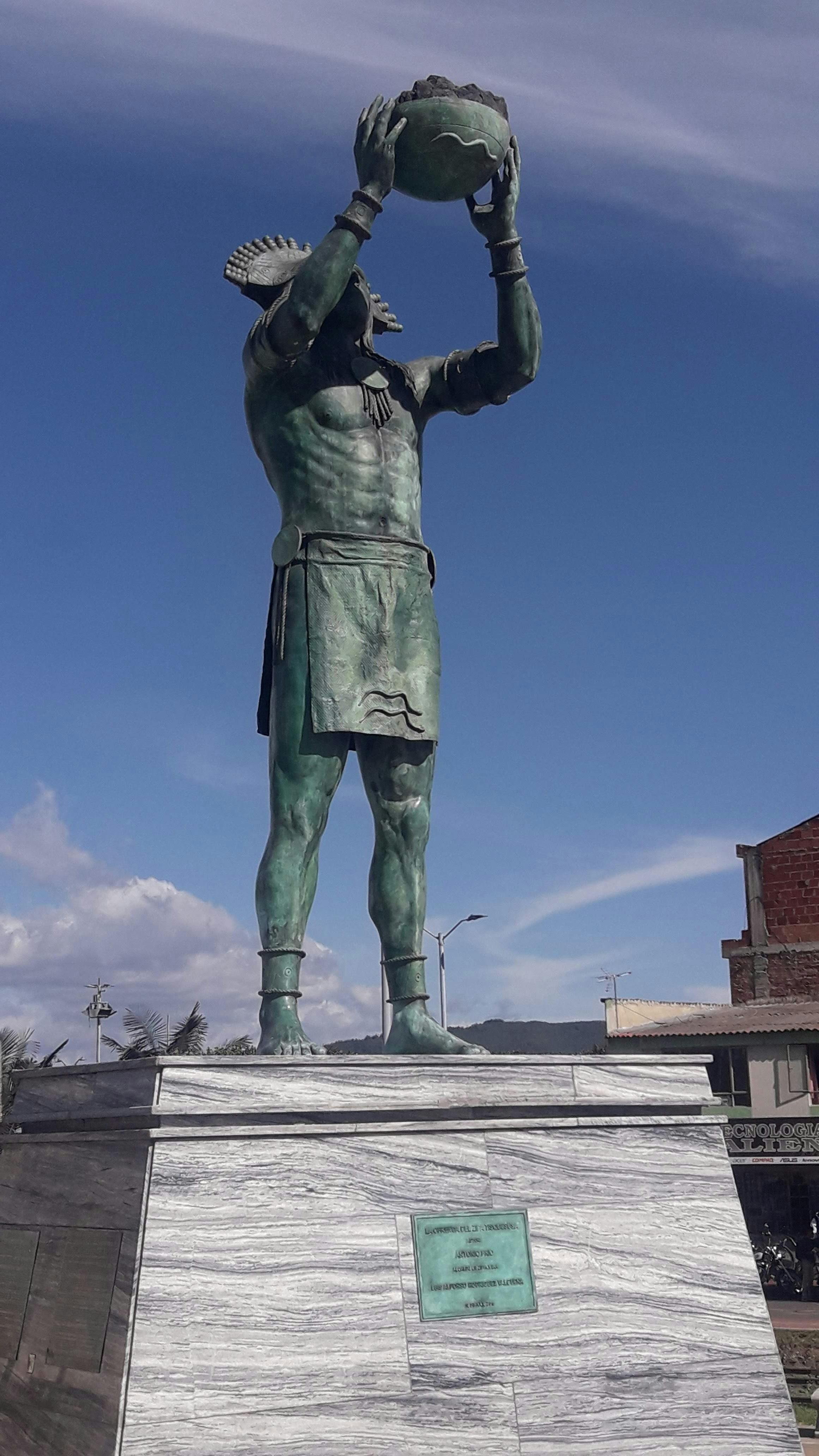 Statue of Tisquesusa in Zipaquirá, Colombia with a clear blue sky backdrop.