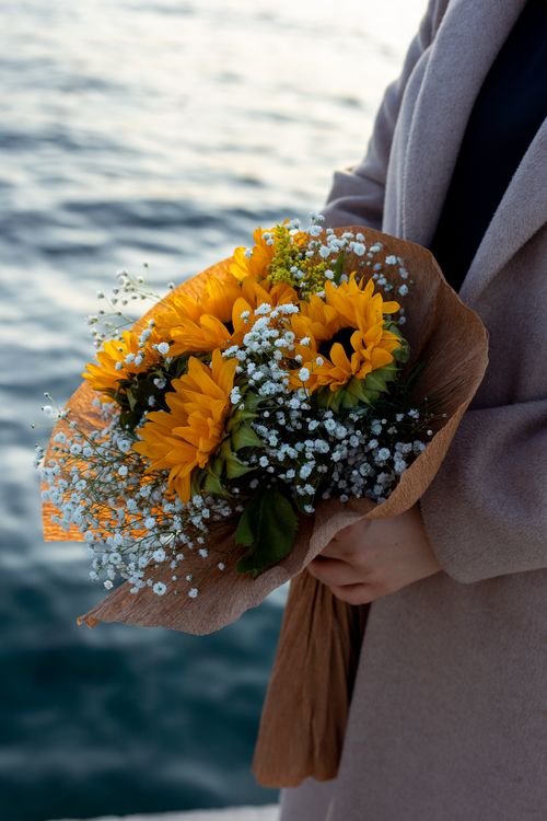 Vibrant Yellow Bouquet by the Water · Free Stock Photo