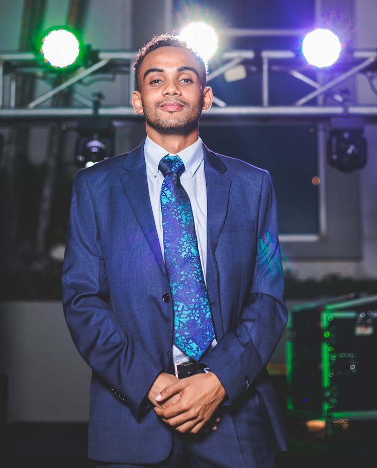 Man In A Suit Posing At An Event