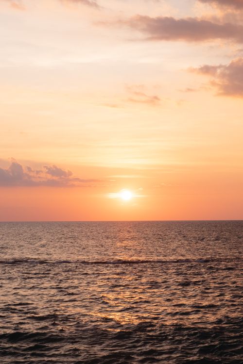 Free Capture the serene beauty of a sunset over an open ocean horizon. Stock Photo