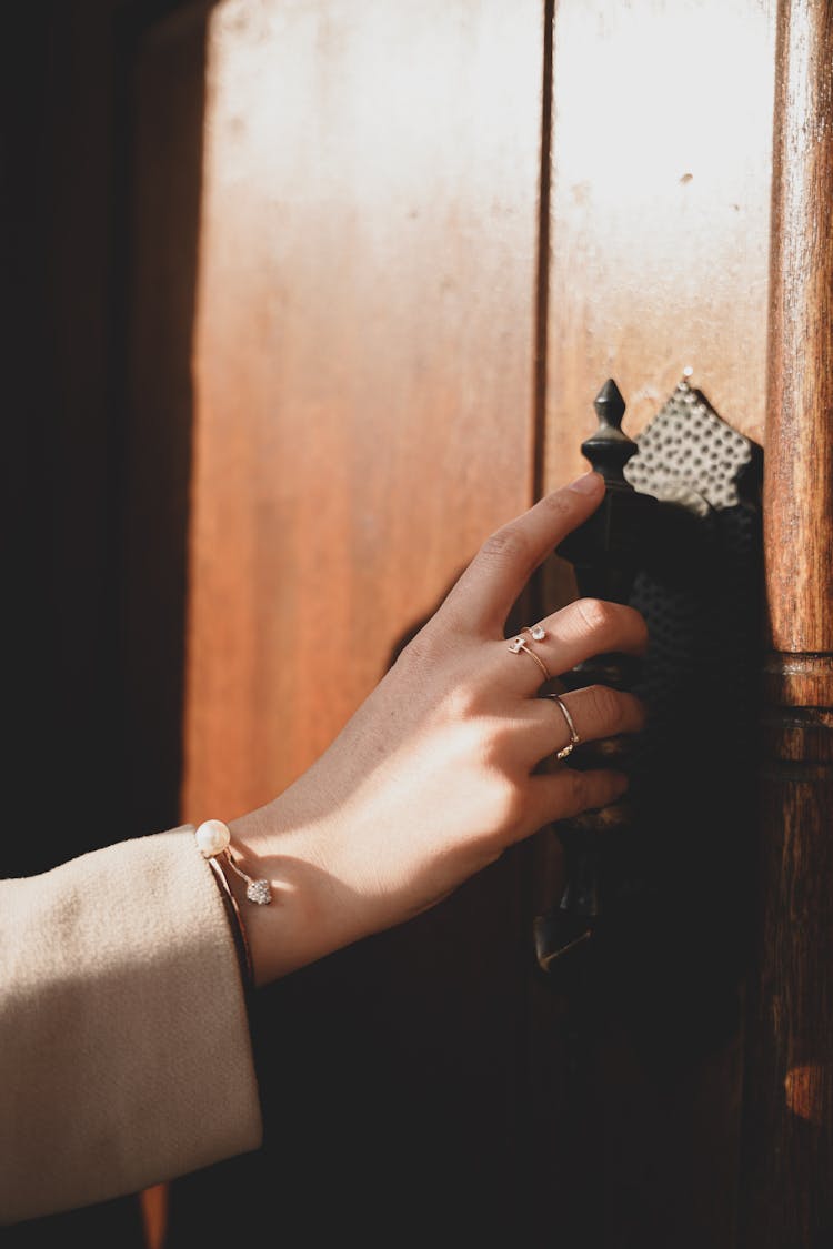 Close-up Of Woman Grabbing The Door Handle