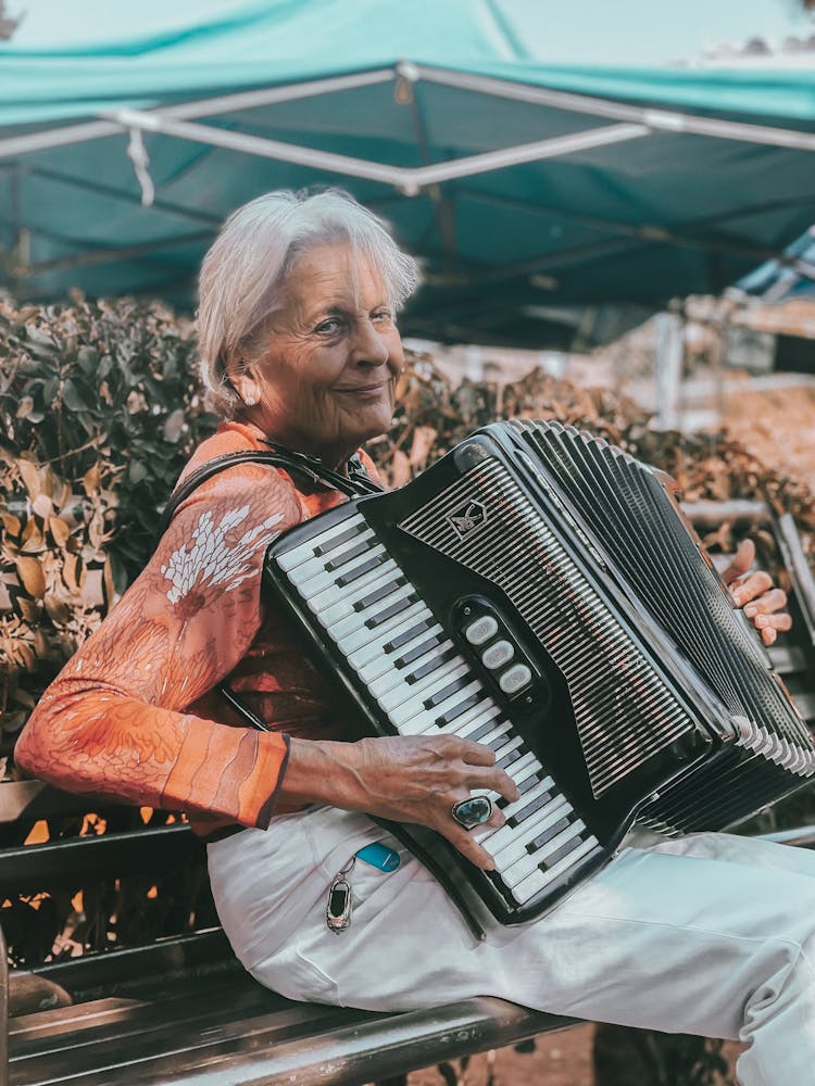 Elderly Woman Playing On Accordion