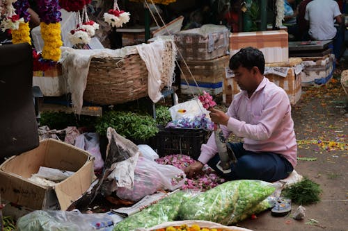 Man making pink flower garland