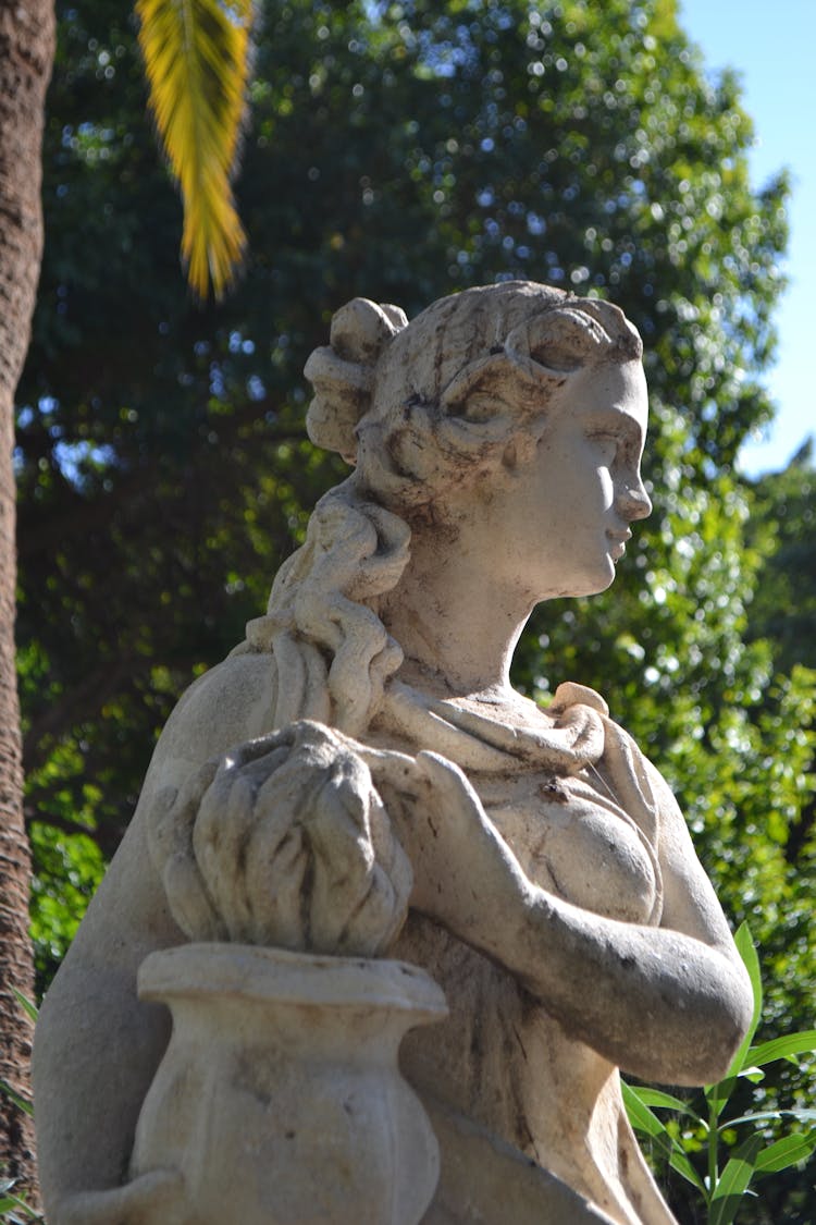 Stone Sculpture In Green Garden