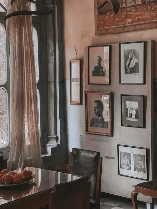 Free Classic vintage room with historical portraits, wooden furniture, and natural lighting. Stock Photo