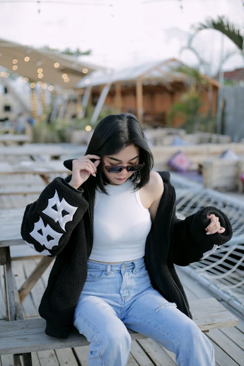A Woman Wearing a Black Jacket over a White Crop Top