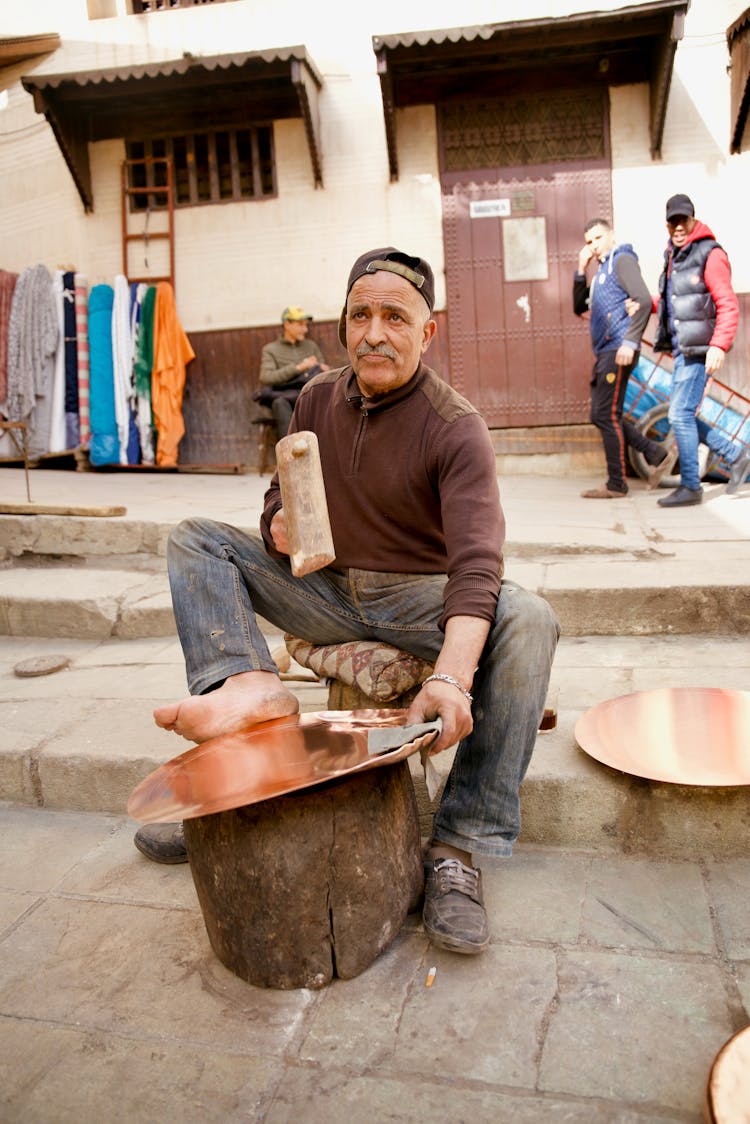 Senior Man Making A Copper Tray At A Bazaar In Morocco