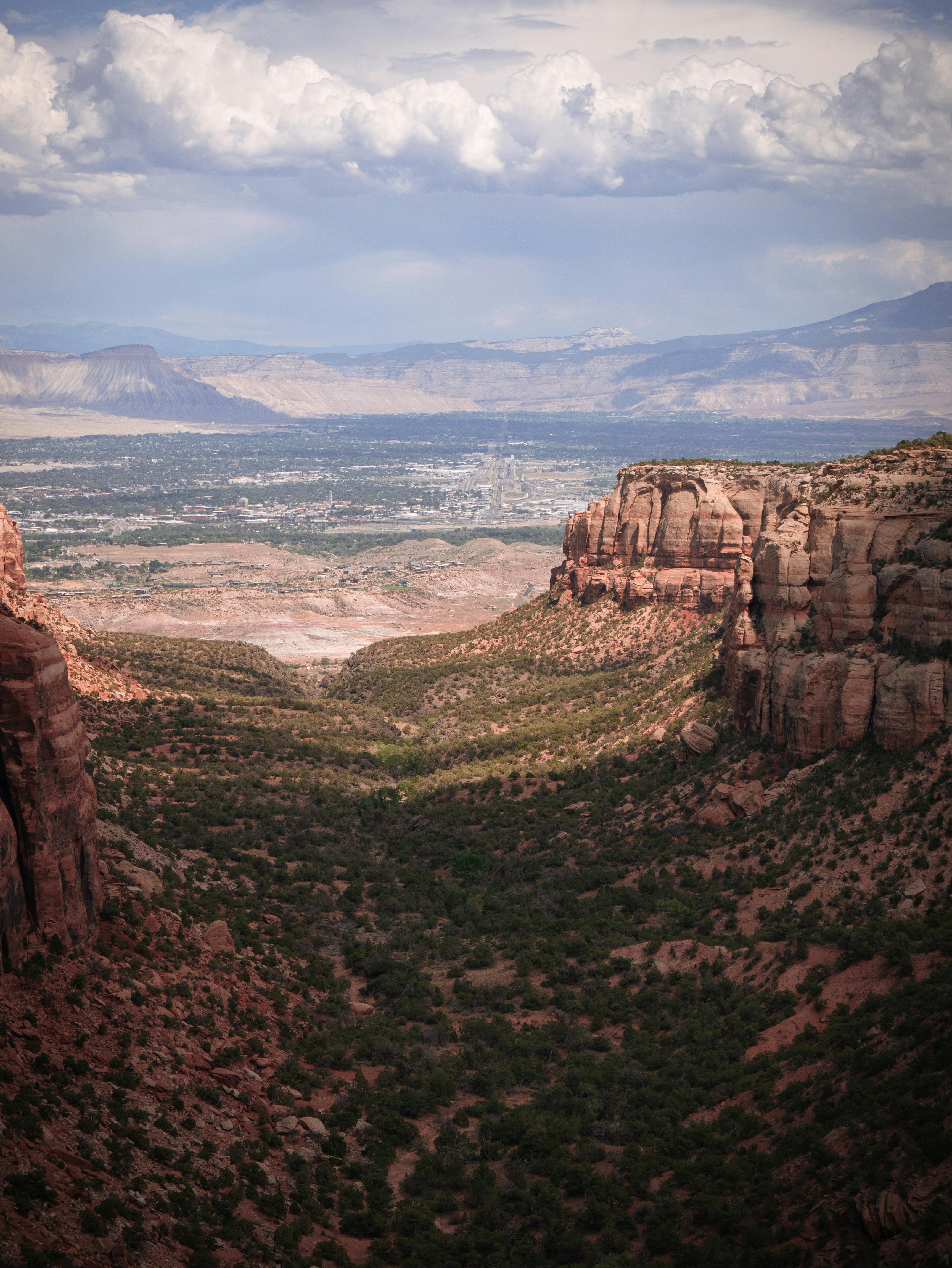 A stunning aerial view of Colorado's vast and rugged natural terrain with dramatic rock formations.