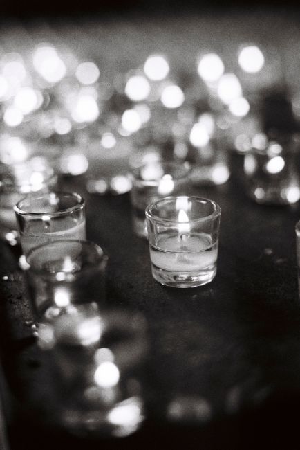Glass candles flicker softly, creating a serene monochrome ambiance.