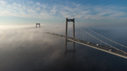 Suspension Bridge Obscured by Clouds