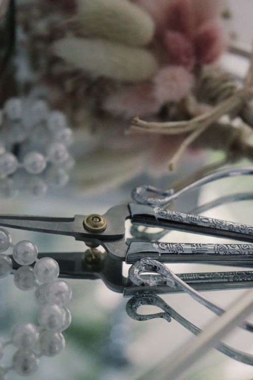 Free Close-up of elegant pliers with beads and floral accents, offering precision and charm. Stock Photo