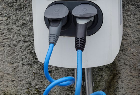 Charging post with two connector cables — photo by Magda Ehlers on Pexels