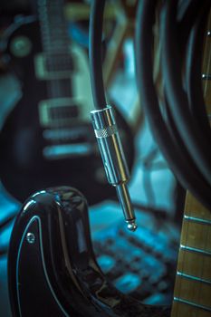 Close-up of an electric guitar with a mono jack connector showcasing music equipment details.