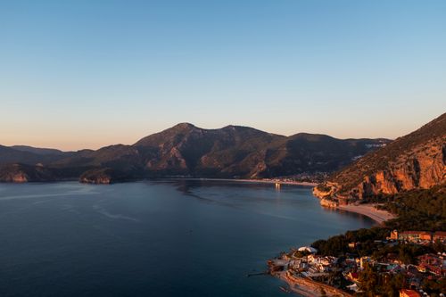 Free Breathtaking aerial view of Ölüdeniz coastline featuring mountains and serene sea during dawn. Stock Photo