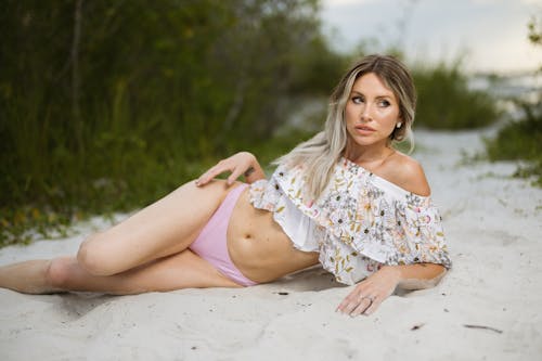 A Woman Lying on the Sand and Posing