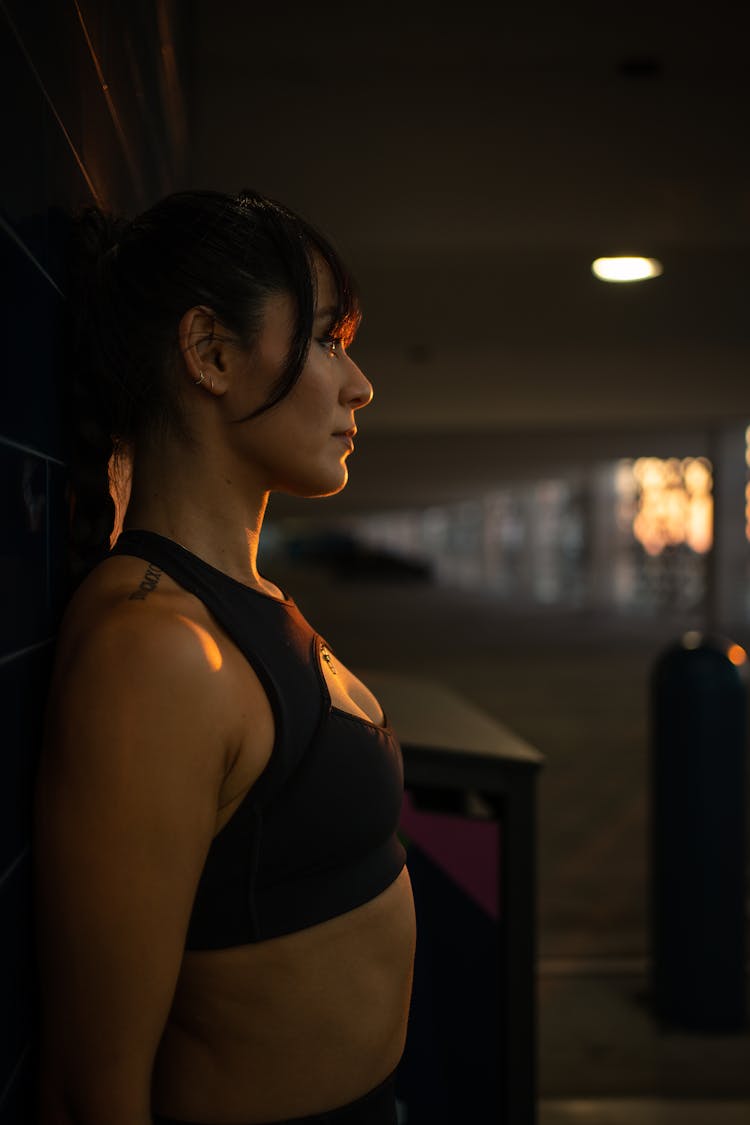 Woman In Bra Posing By Wall