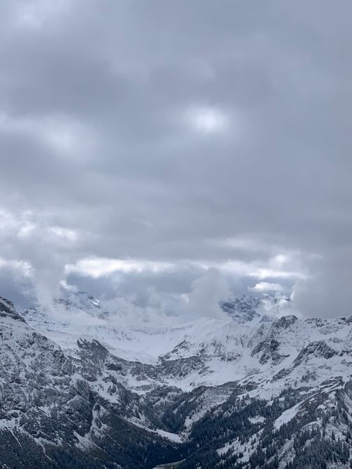Free Breathtaking view of the snowcapped Austrian Alps in winter under an overcast sky. Stock Photo