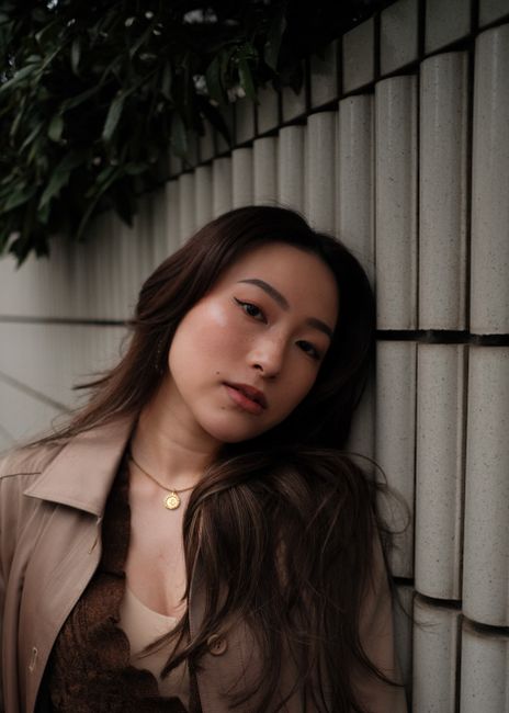 Portrait of a stylish woman leaning on a wall in Tokyo, Japan.