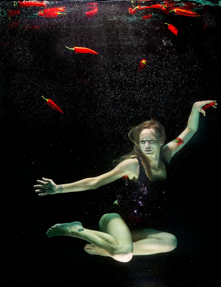 Woman Underwater Wearing Black One Piece Swimsuit