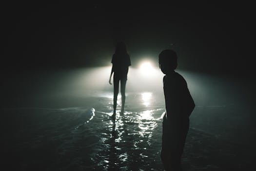 Eerie night scene with children's silhouetted figures against car lights, creating a mysterious atmosphere.