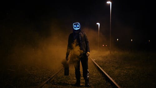 Man Wearing Black Jacket Standing On Railroad
