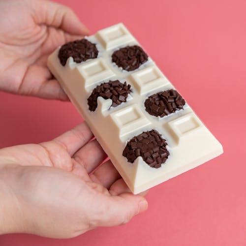 Hands Holding a White Chocolate Bar 
