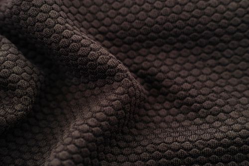 Free Detailed close-up view of brown textured fabric with a hexagonal pattern. Stock Photo