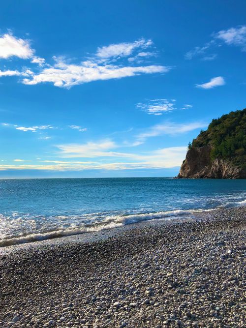 Free Peaceful rocky beach with turquoise sea and clear blue sky in Montenegro. Stock Photo