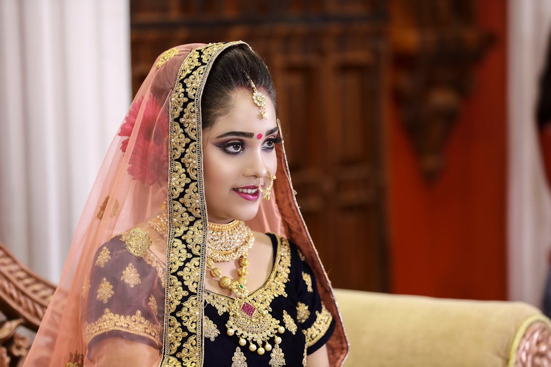 Woman Wearing Black and Gold Sari
