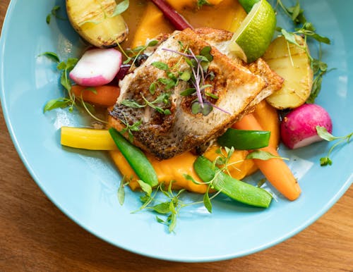 Fried Fish With Vegetables Dish on Teal Plate